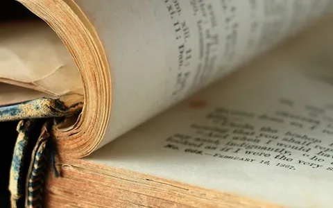 an open book laying on top of an open book