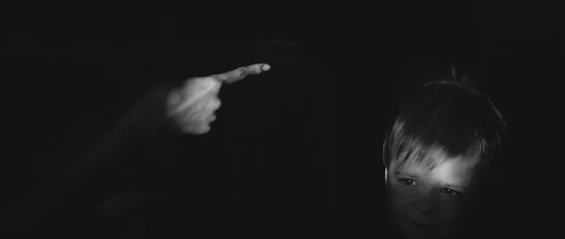 grayscale photo of girl holding her chin
