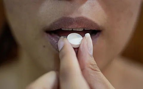 woman putting her hand on her lips