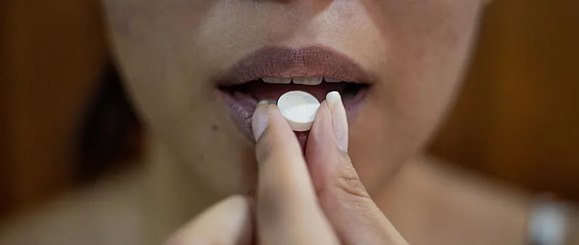 woman putting her hand on her lips