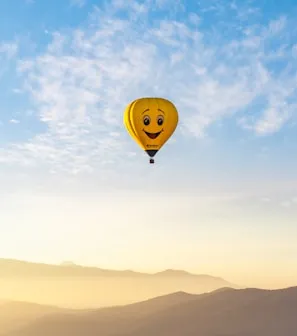 a hot air balloon with a smiley face on it